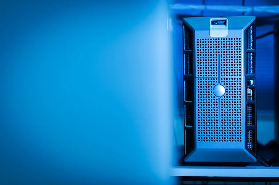 a server tower in a blue-lit server room