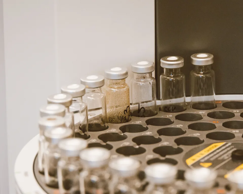 A close-up view of glass bottles and vials arranged in a laboratory setting.