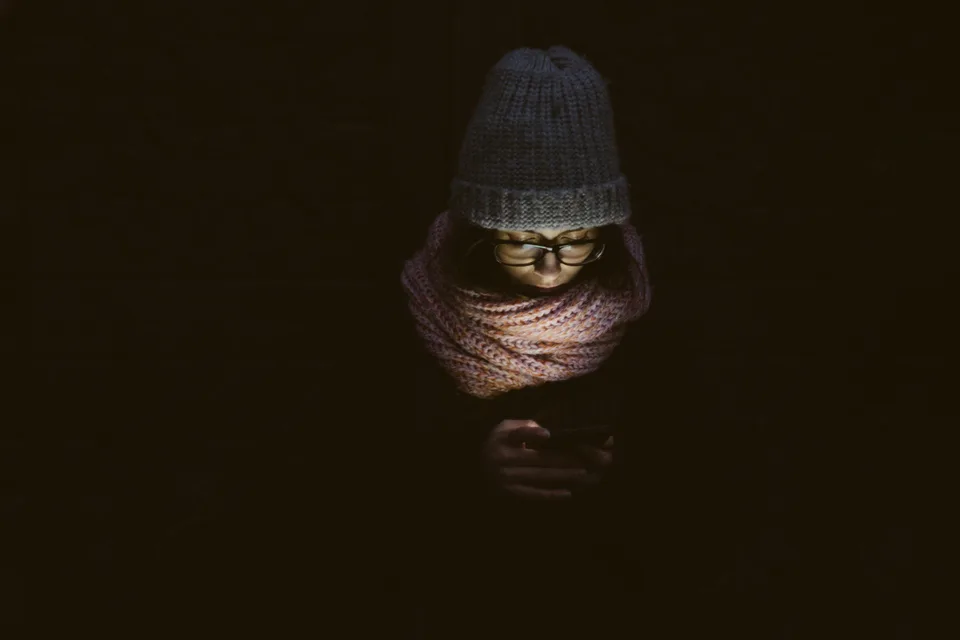 A woman using her smartphone in a quiet, contemplative setting.