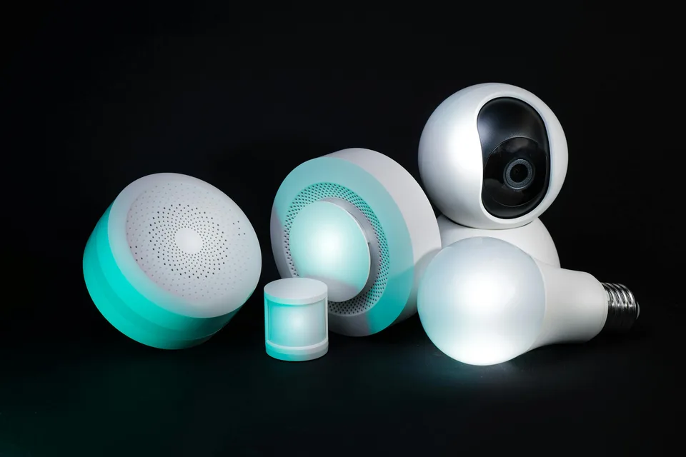 Modern smart-home devices including connected lights and sensors arranged on a table.
