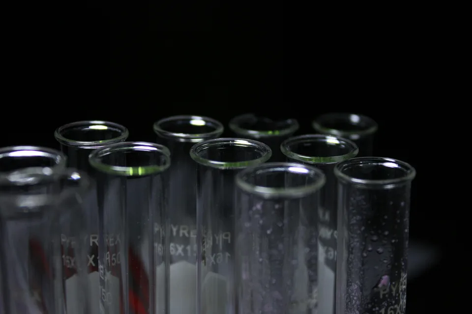 A close-up of laboratory test tubes containing chemical samples in a science setting.