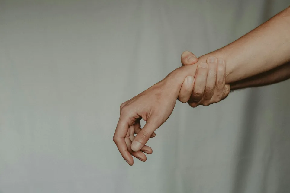 A close-up of hands held gently together, representing connection and calm.