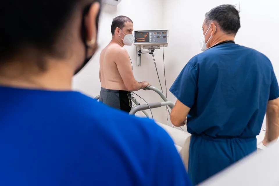 A medical professional treating a patient during a hospital procedure.