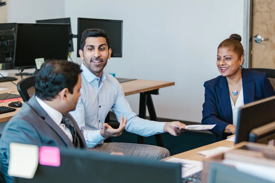 Two people engaged in conversation, discussing information together.