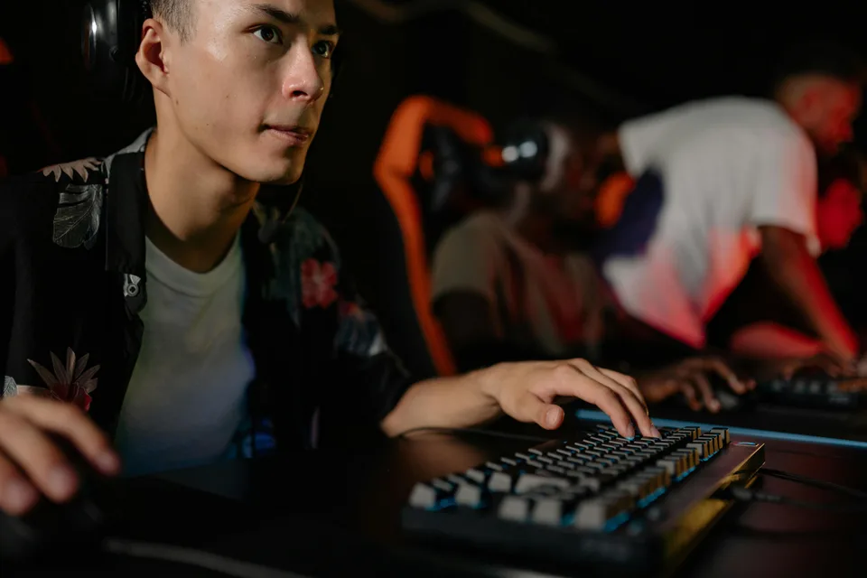 Close-up of a player's hands on a mechanical keyboard during competitive gaming.