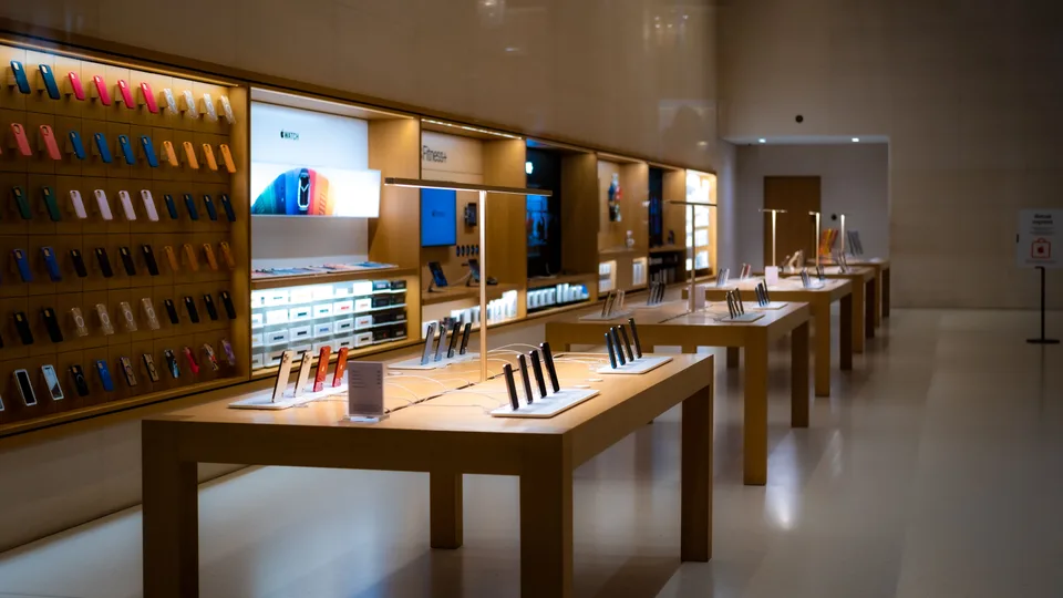 retail store tables and shelves displaying rows of smartphones