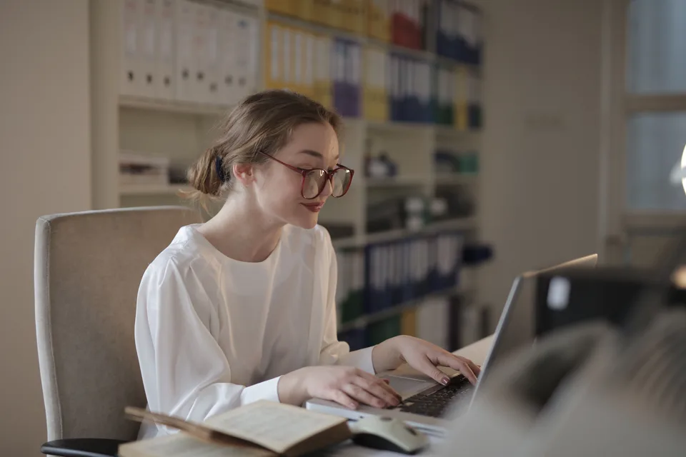 Person working at a laptop in a quiet modern office