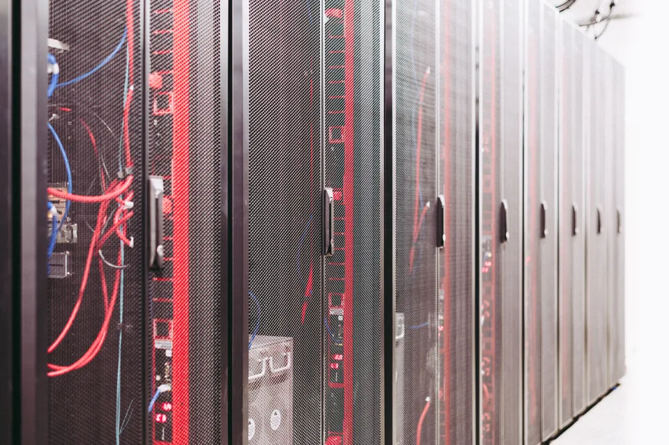 Rows of illuminated server racks in a data center