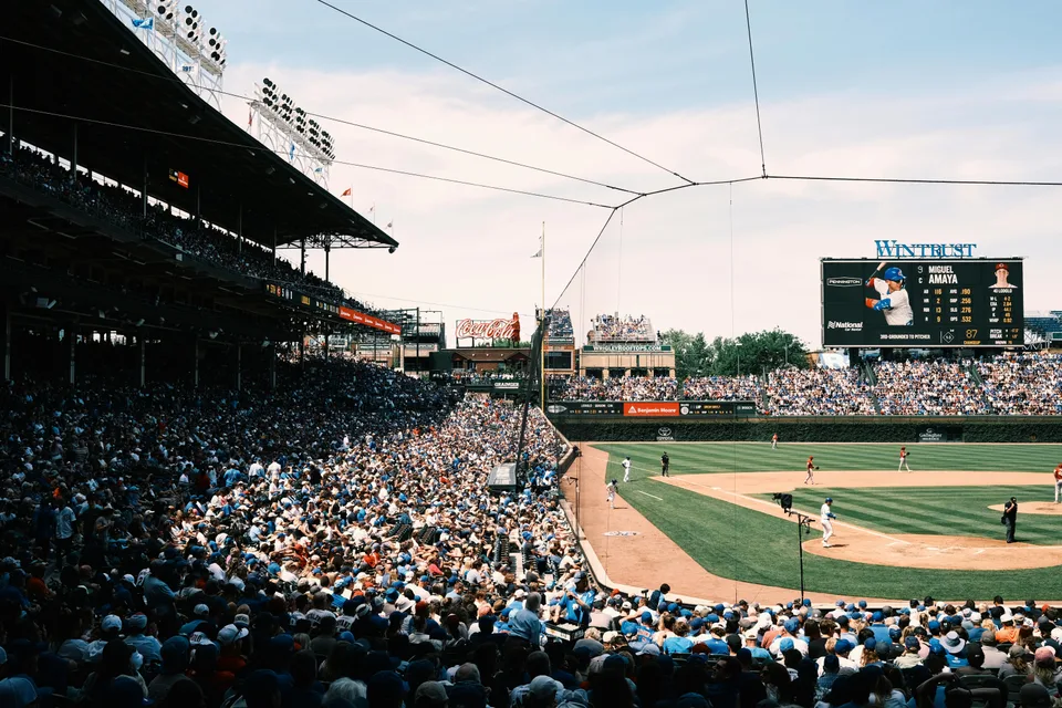 View of a baseball game from the stands at Chicago's Wrigley Field, fans watching the play below.