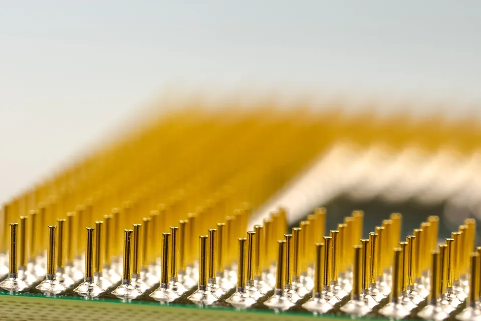 A macro photograph showing the detailed pins on a computer processor chip.
