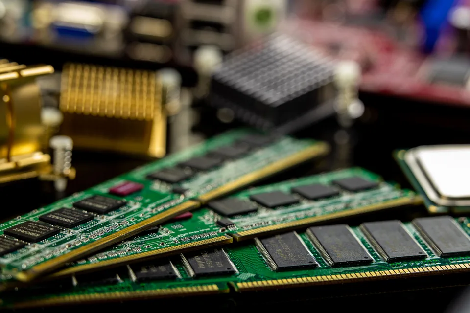 close-up of a green and black computer memory module on a dark surface