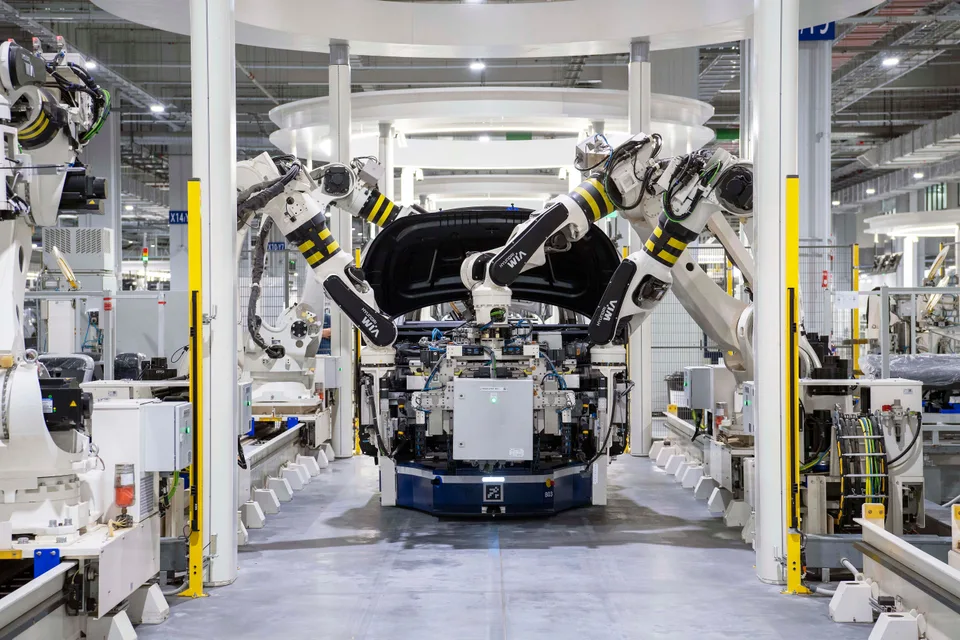 Automated assembling machines operating in a large-scale manufacturing factory.