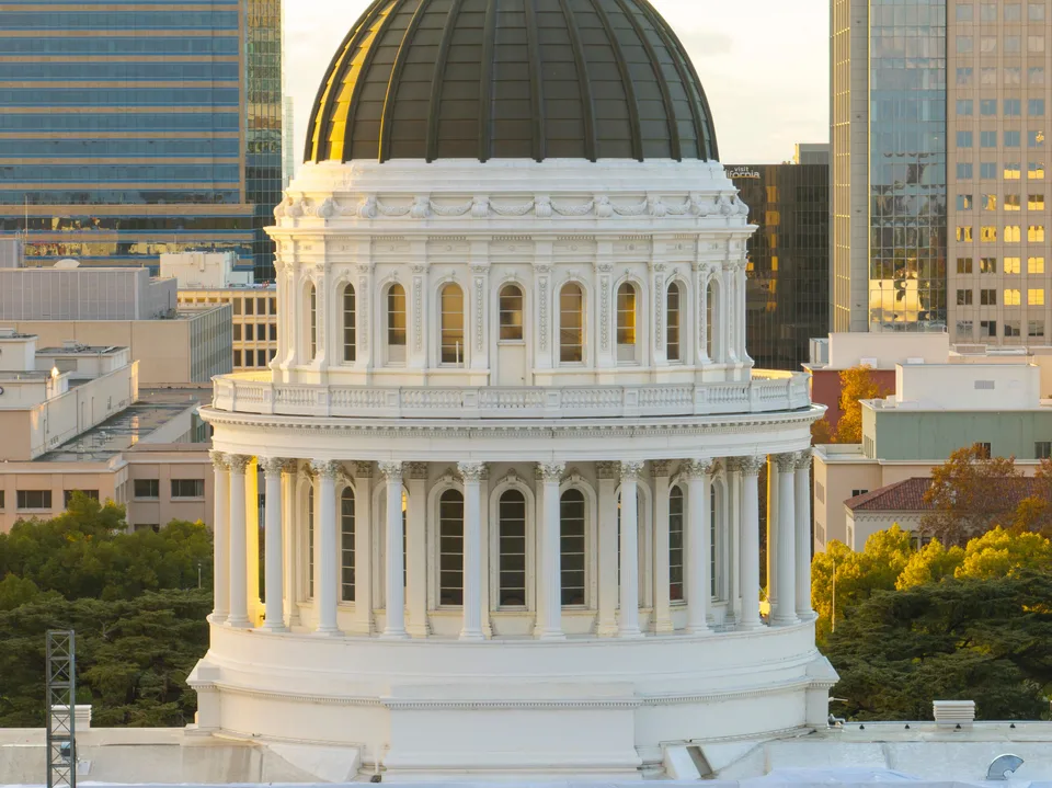 domed state capitol building at sunset