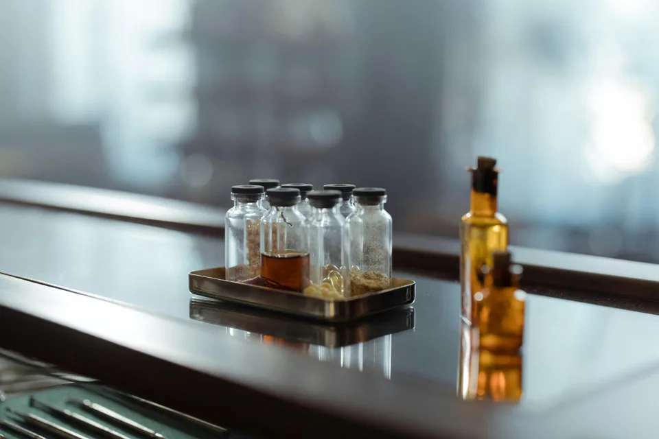 Pharmacy bottles and prescription medications arranged on a wooden surface.